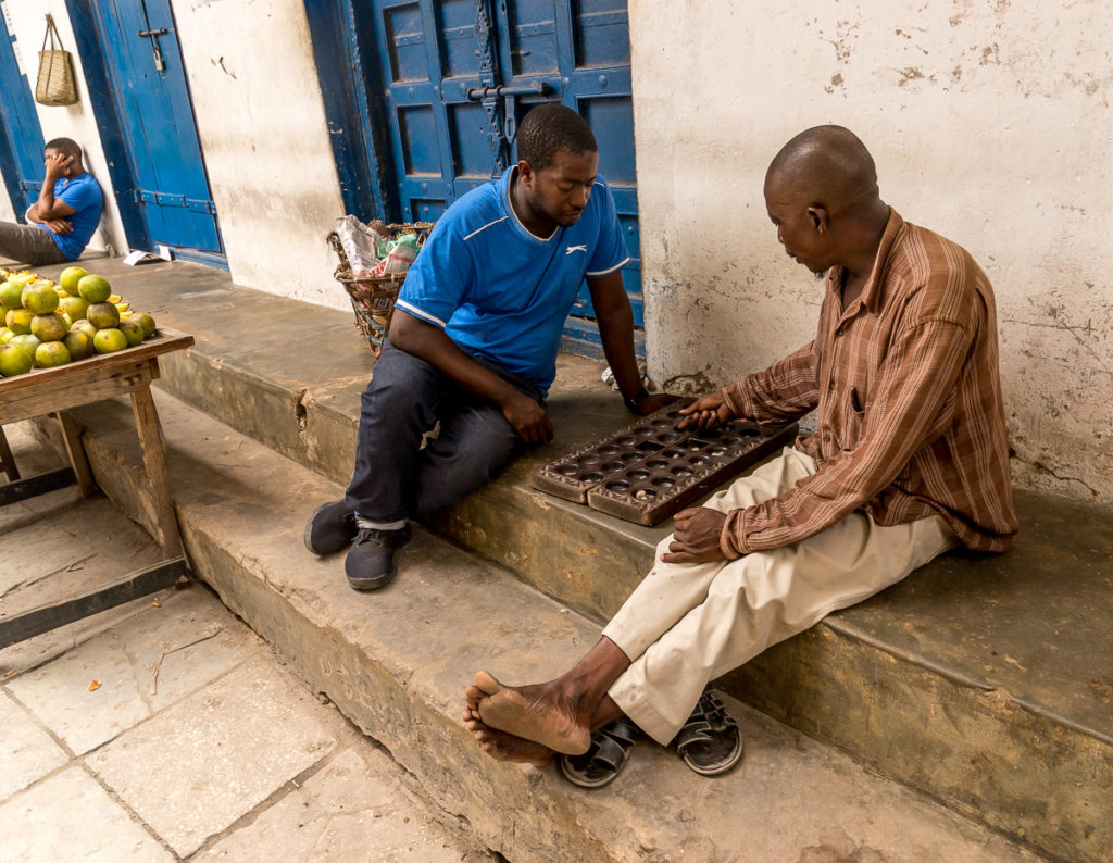 Two men playing the game of bao, Stone Town, Zanzibar. Photo: Andy Morgan