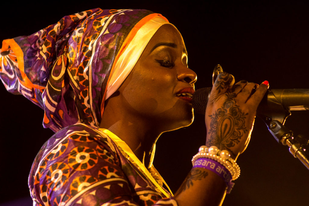Siti Amina Omar with henna'd hands, on stage with the Tausi Women's Taarab Orchestra, Sauti za Busara 2019, Zanzibar. Photo: Andy Morgan