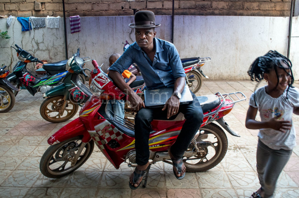 Omar Toure from Songhoy Blues sitting on his motorbike, Bamako, Mali - 2014. Photo: Andy Morgan