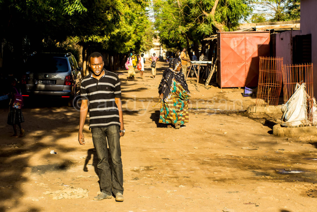 Ali from Songhoy Blues walking through Laffiabougou district, Bamako, Mali, 2014. Photo: Andy Morgan