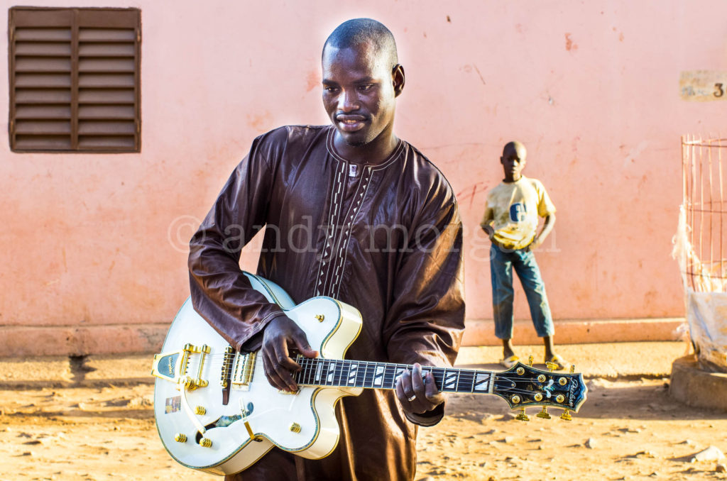 Garba from Songhoy Blues playing his white semi-acoustic, Laffiabougou, Bamako, Mali. Photo: Andy Morgan